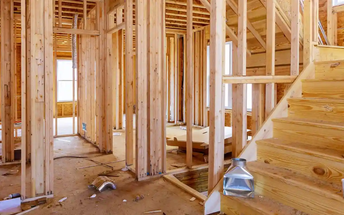 Structural carpentry and stair framing on site, illustrating the labour priced in carpenter services cost Structural carpentry and stair framing on site, illustrating the labour priced in carpenter services cost