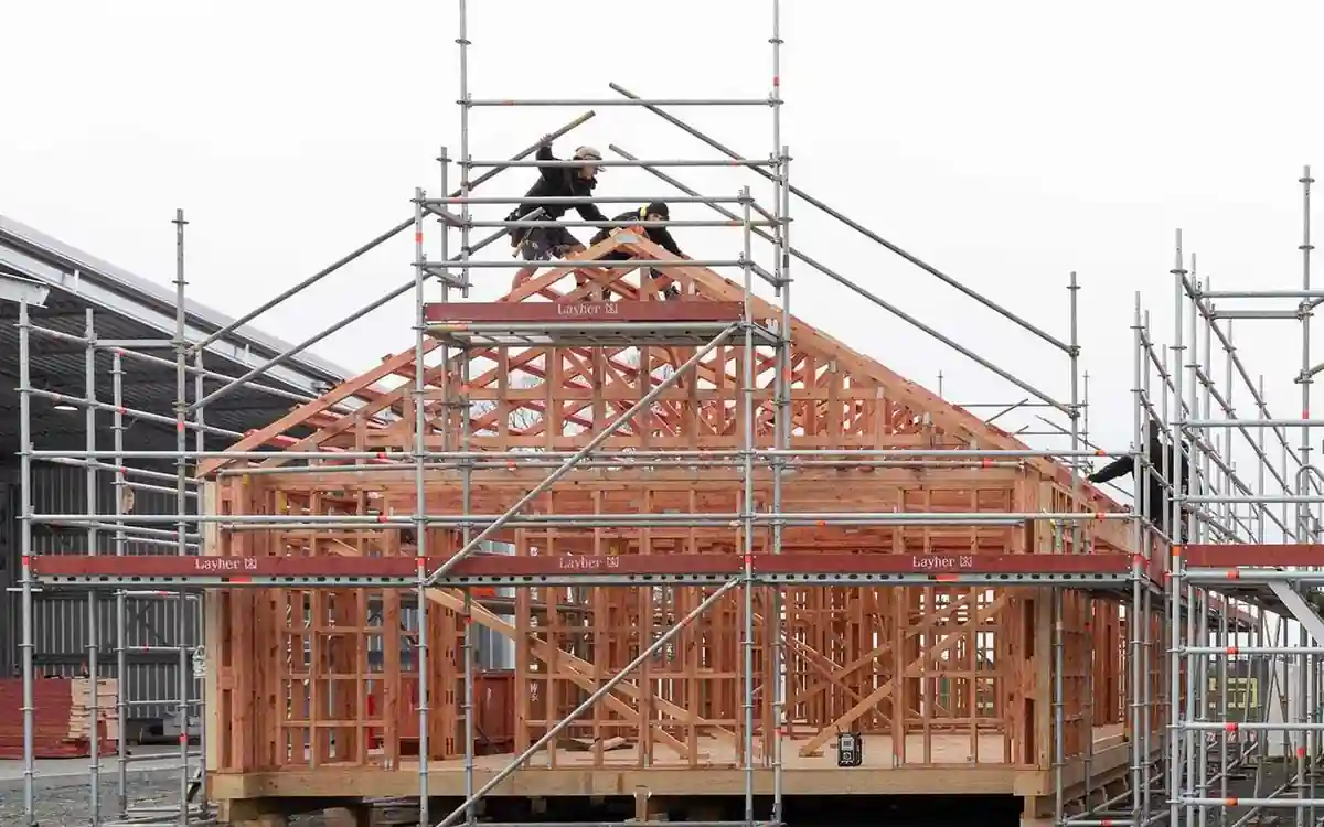 Timber-framed Auckland house under scaffold, showing the structural carpenter services available locally