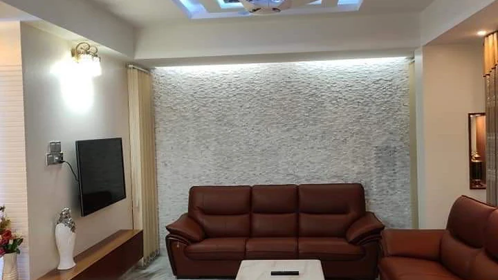 Finished living space with layered lighting and a stone feature wall, the standard of fit-out reflected in renovation cost Finished living space with layered lighting and a stone feature wall, the standard of fit-out reflected in renovation cost