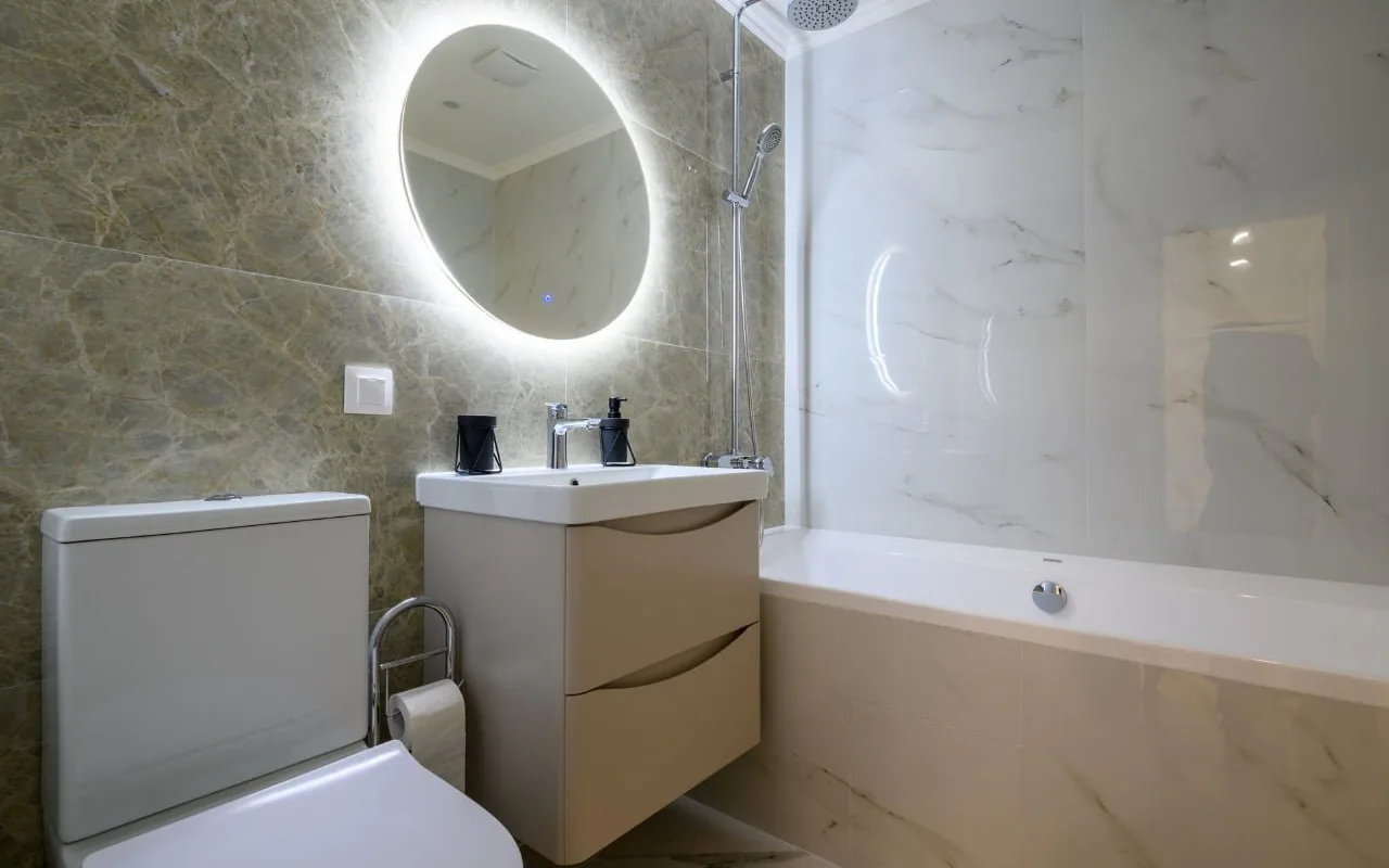 Low-cost bathroom renovation that keeps existing plumbing positions and limits the tiled area Low-cost bathroom renovation that keeps existing plumbing positions and limits the tiled area