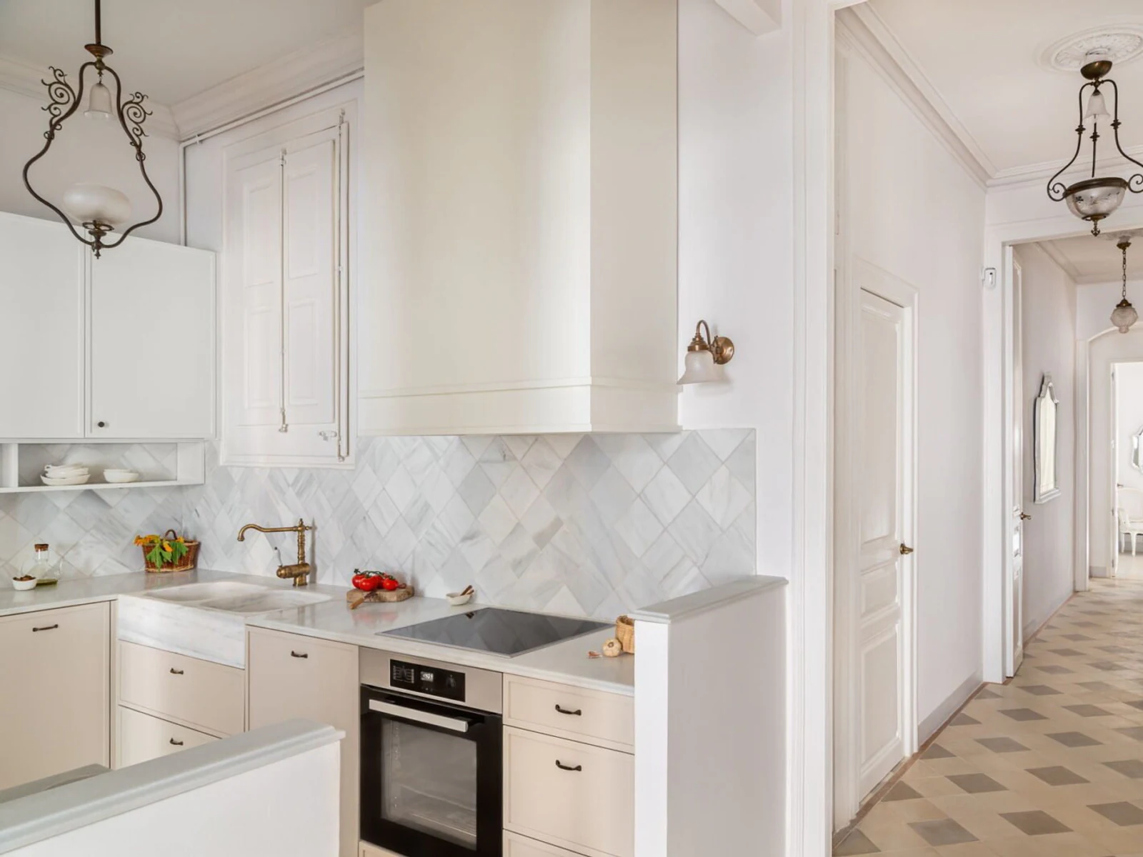 Bright renovated kitchen with new cabinetry and marble-style splashback in an Auckland home