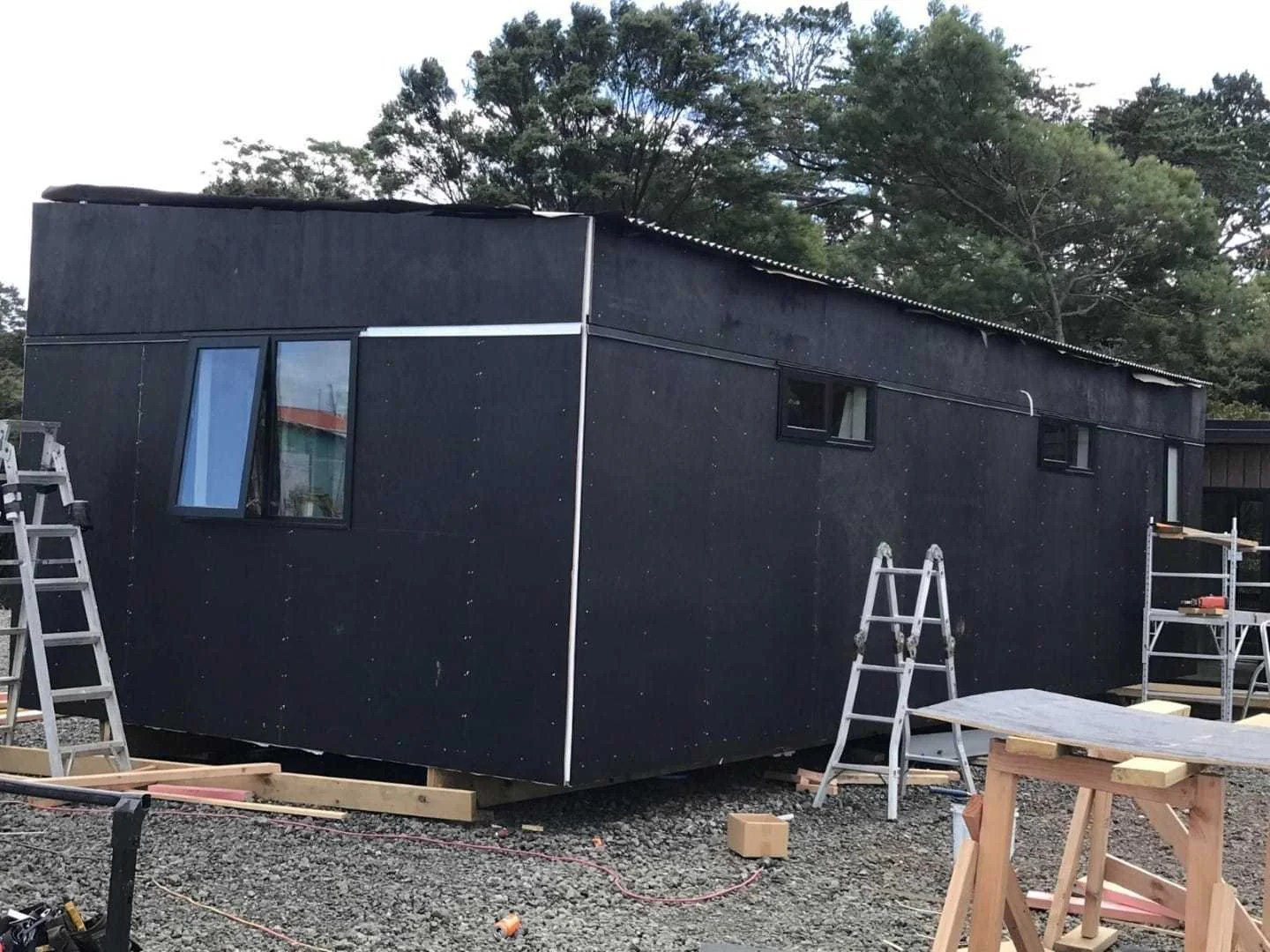 Larger tiny home under construction with weathertight wrap applied